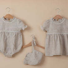 Load image into Gallery viewer, natural flax linen dress, bonnet and onesie for baby girl or toddler girl on beige background.