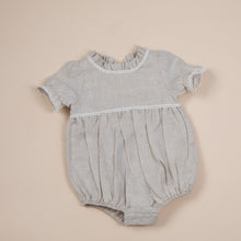 Load image into Gallery viewer, a natural flax linen onesie with white trim detail for baby girl or toddler girl on beige background