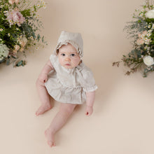 Load image into Gallery viewer, a natural flax linen onesie with white trim detail for baby girl or toddler girl on beige background