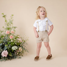 Load image into Gallery viewer, white cotton short sleeve top with peter pan collar and piping for baby boy or toddler boy on beige background.