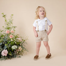 Load image into Gallery viewer, white cotton short sleeve top with peter pan collar and piping for baby boy or toddler boy on beige background.
